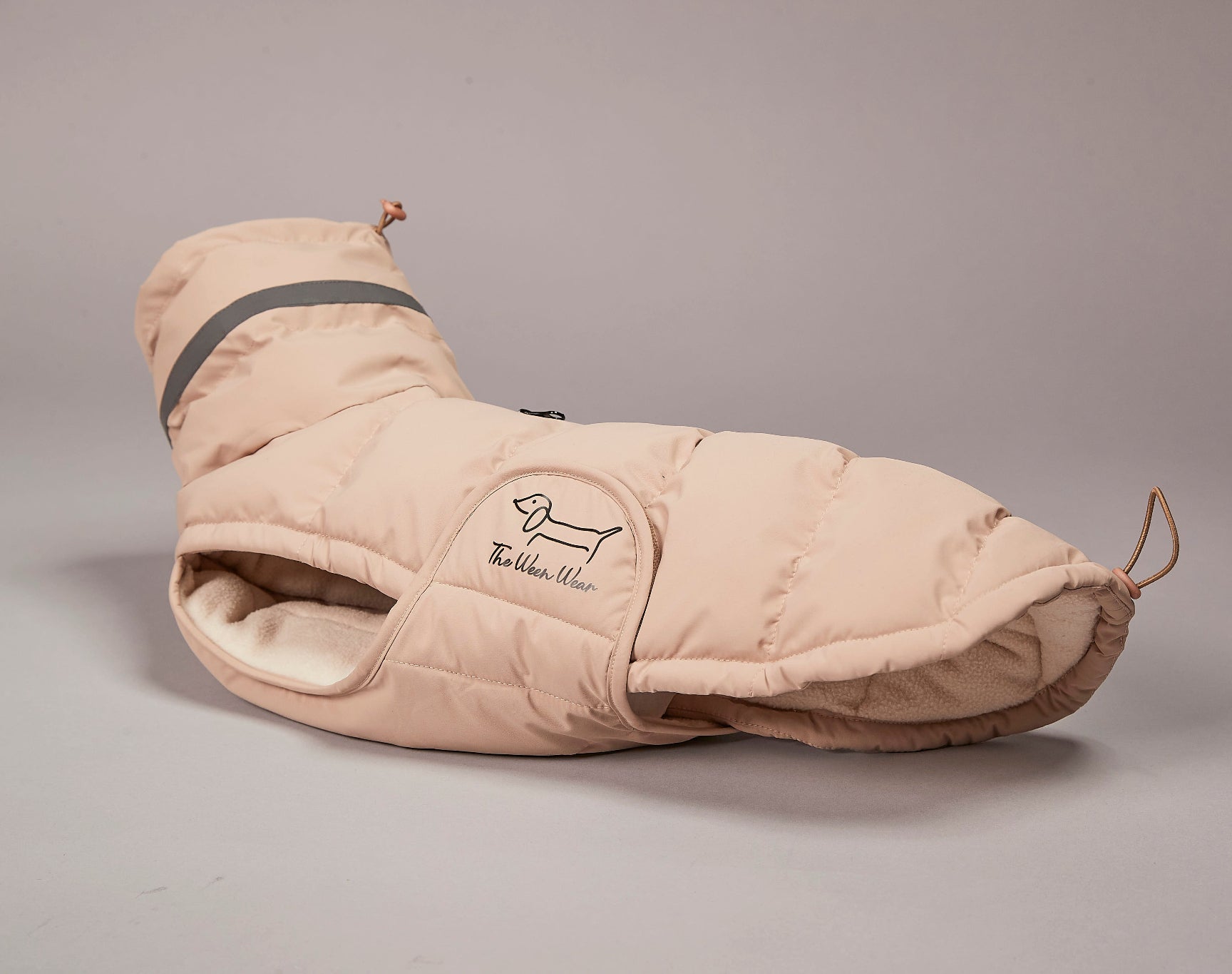 Beige dog coat with a brand logo on a gray background